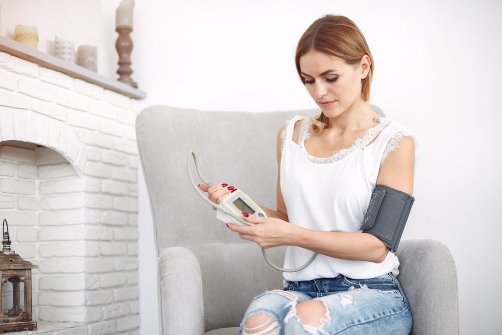 woman monitors high blood pressure